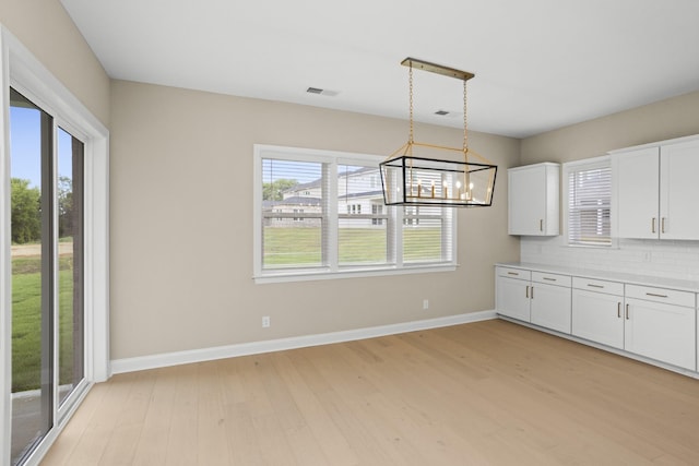 5971 Hunt Valley Dr, Spring Hill, TN 37174 - unfurnished dining area with light wood-style floors and a chandelier