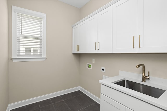 5971 Hunt Valley Dr, Spring Hill, TN 37174 - laundry area with electric dryer hookup, hookup for a washing machine, cabinet space, and dark tile patterned floors