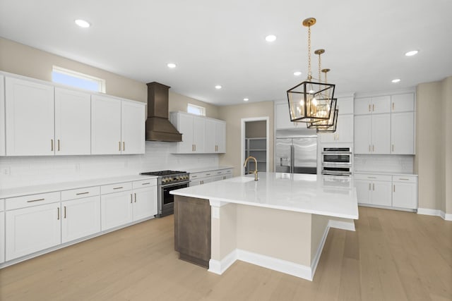 5971 Hunt Valley Dr, Spring Hill, TN 37174 - kitchen with high quality appliances, premium range hood, tasteful backsplash, a chandelier, and light wood-style flooring