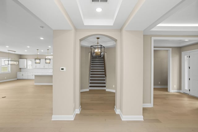 5971 Hunt Valley Dr, Spring Hill, TN 37174 - entryway featuring stairway, light wood finished floors, arched walkways, recessed lighting, and a raised ceiling