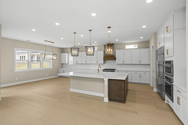 5971 Hunt Valley Dr, Spring Hill, TN 37174 - kitchen featuring stainless steel appliances, light countertops, tasteful backsplash, premium range hood, and recessed lighting