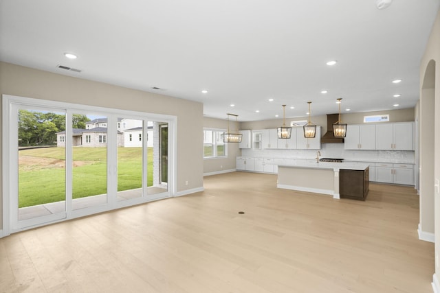 5971 Hunt Valley Dr, Spring Hill, TN 37174 - unfurnished living room with light wood finished floors, recessed lighting, and arched walkways