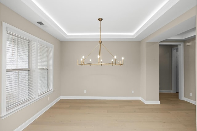 5971 Hunt Valley Dr, Spring Hill, TN 37174 - empty room with a chandelier, a tray ceiling, and light wood finished floors