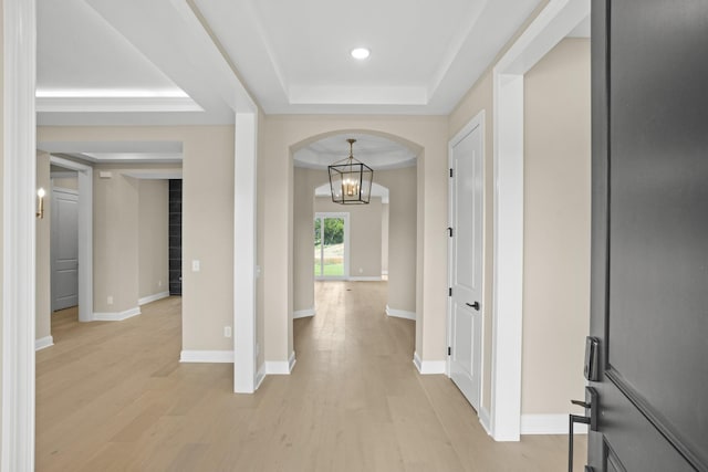 5971 Hunt Valley Dr, Spring Hill, TN 37174 - entryway featuring arched walkways, a raised ceiling, light wood-style floors, a chandelier, and recessed lighting