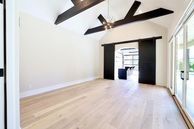 1266 Potter Ln, Gallatin, TN 37066 - spare room featuring a barn door, beam ceiling, wood finished floors, high vaulted ceiling, and baseboards