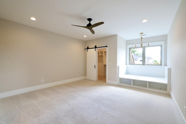 1266 Potter Ln, Gallatin, TN 37066 - unfurnished bedroom featuring light colored carpet, a barn door, recessed lighting, baseboards, and a walk in closet