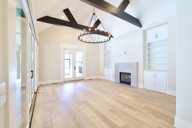 1266 Potter Ln, Gallatin, TN 37066 - unfurnished living room featuring beam ceiling, light wood finished floors, a chandelier, french doors, and high vaulted ceiling