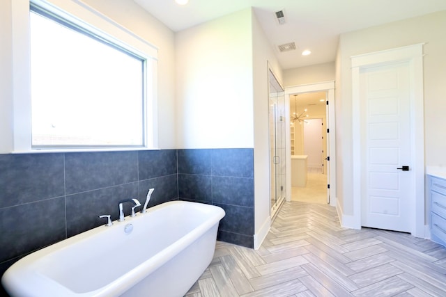 1266 Potter Ln, Gallatin, TN 37066 - bathroom featuring a freestanding tub, a shower stall, tile walls, recessed lighting, and vanity