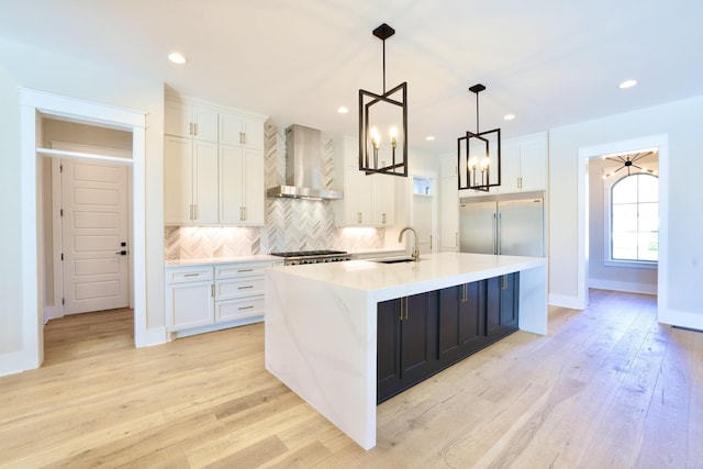 1266 Potter Ln, Gallatin, TN 37066 - kitchen featuring wall chimney exhaust hood, a sink, built in fridge, white cabinets, and tasteful backsplash