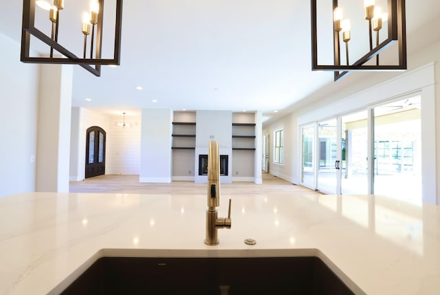 1266 Potter Ln, Gallatin, TN 37066 - kitchen featuring a chandelier, light stone counters, recessed lighting, open floor plan, and a sink