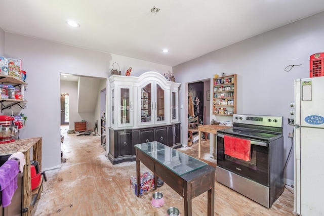 3396 Unionville Rd, Halls, TN 38040 - kitchen with stainless steel electric range, white cabinets, freestanding refrigerator, glass insert cabinets, and recessed lighting