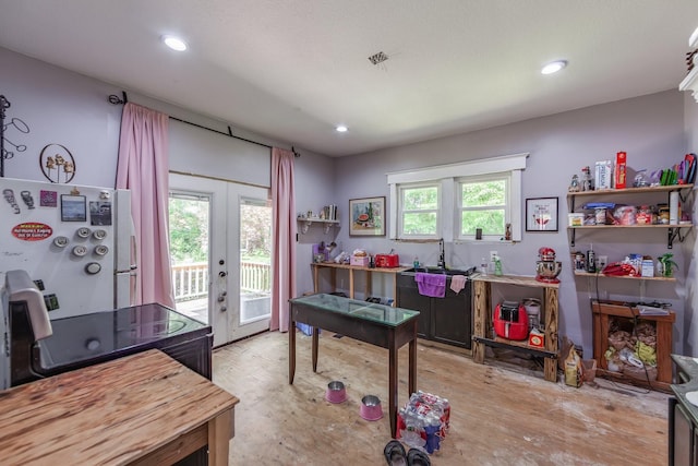 3396 Unionville Rd, Halls, TN 38040 - office area featuring french doors, recessed lighting, light wood-style floors, and a sink