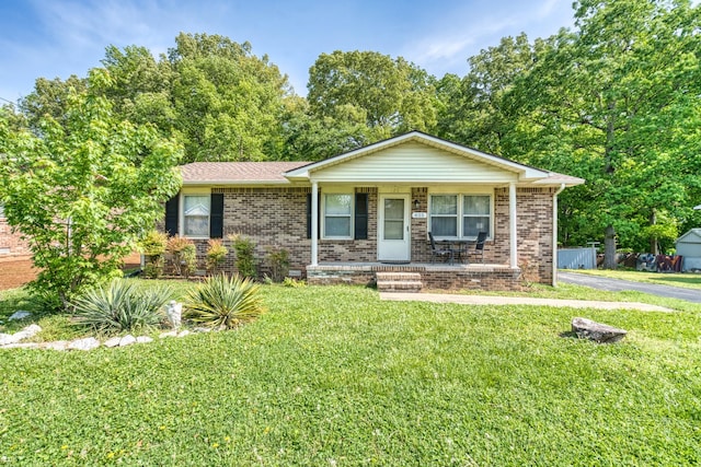 825 Oak St, Franklin, KY 42134 - view of front of property featuring a porch, a front lawn, and brick siding