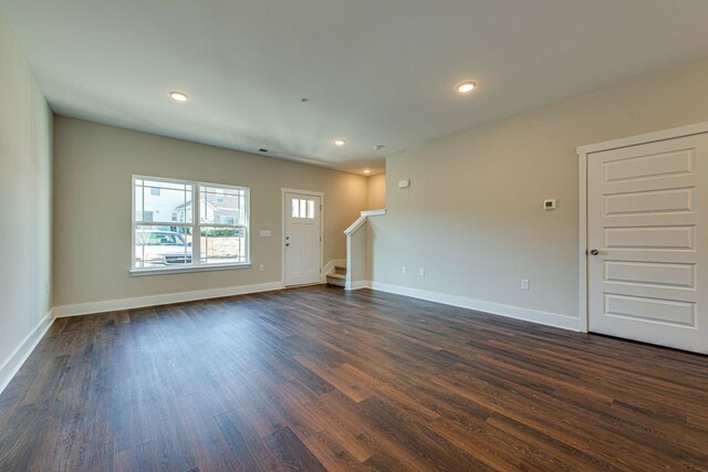 3010 Coriander Dr, Spring Hill, TN 37174 - unfurnished living room with dark wood-style flooring, stairway, baseboards, and recessed lighting