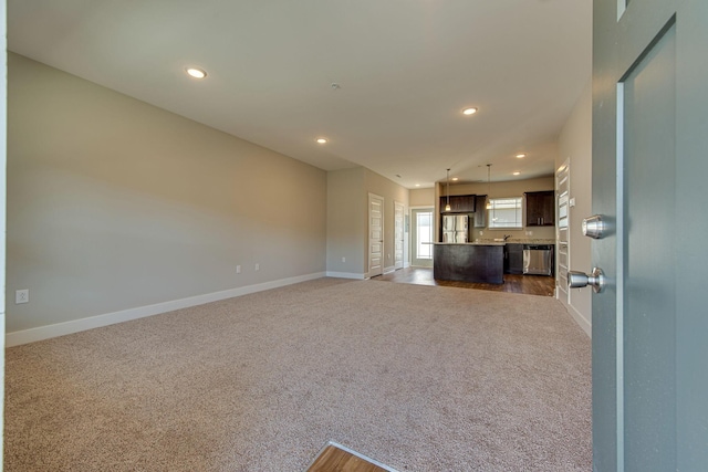 3010 Coriander Dr, Spring Hill, TN 37174 - unfurnished living room with dark colored carpet, baseboards, and recessed lighting
