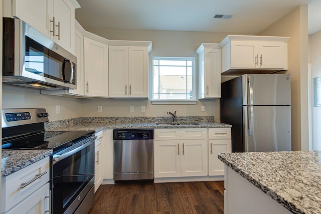 3010 Coriander Dr, Spring Hill, TN 37174 - kitchen featuring appliances with stainless steel finishes, a sink, dark wood finished floors, and white cabinets
