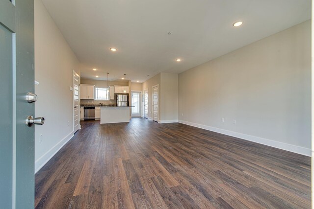 3010 Coriander Dr, Spring Hill, TN 37174 - unfurnished living room with dark wood-style floors, baseboards, and recessed lighting