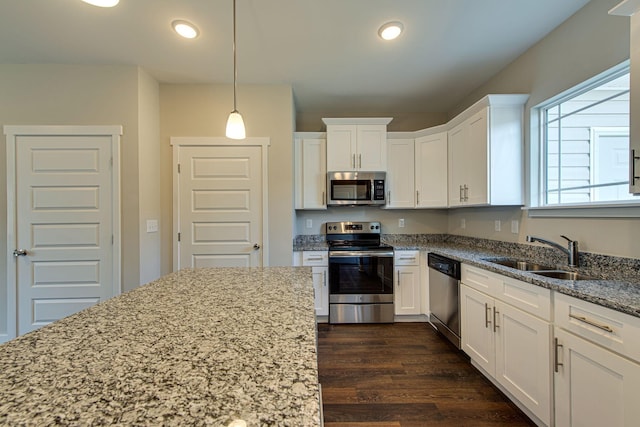 3010 Coriander Dr, Spring Hill, TN 37174 - kitchen featuring appliances with stainless steel finishes, a sink, white cabinets, light stone countertops, and dark wood-style floors