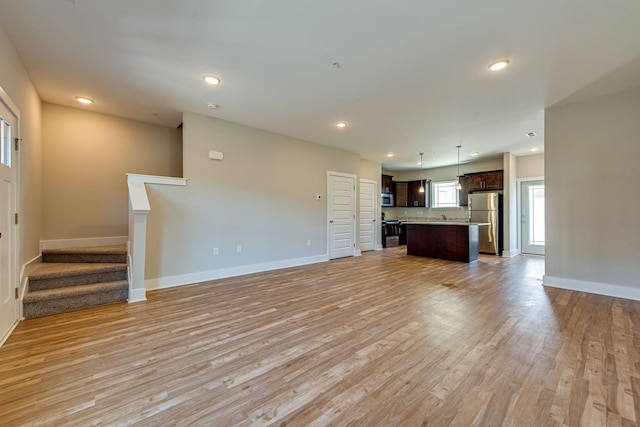 3010 Coriander Dr, Spring Hill, TN 37174 - unfurnished living room with baseboards, light wood finished floors, stairs, and recessed lighting