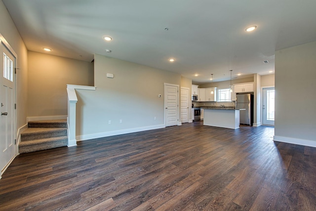 3010 Coriander Dr, Spring Hill, TN 37174 - unfurnished living room featuring dark wood finished floors, baseboards, stairway, and recessed lighting