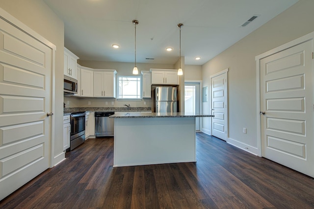 3010 Coriander Dr, Spring Hill, TN 37174 - kitchen featuring stainless steel appliances, a sink, stone counters, white cabinets, and a center island
