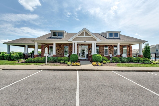 3010 Coriander Dr, Spring Hill, TN 37174 - view of front of house with uncovered parking, a porch, brick siding, and roof with shingles