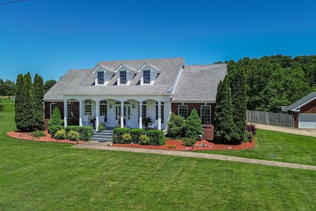 95 Country Ln, Lawrenceburg, TN 38464 - cape cod-style house featuring a porch, brick siding, and a shingled roof