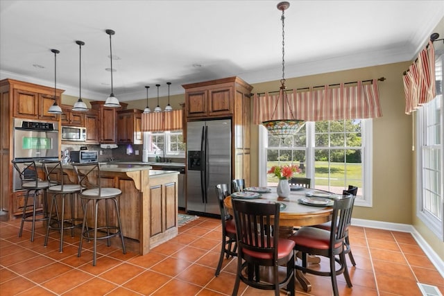 95 Country Ln, Lawrenceburg, TN 38464 - kitchen with appliances with stainless steel finishes, light tile patterned floors, brown cabinets, crown molding, and plenty of natural light