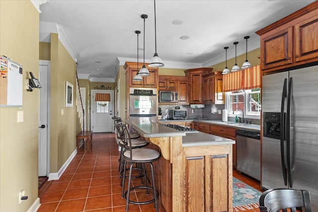95 Country Ln, Lawrenceburg, TN 38464 - kitchen featuring appliances with stainless steel finishes, a sink, dark tile patterned floors, ornamental molding, and brown cabinetry