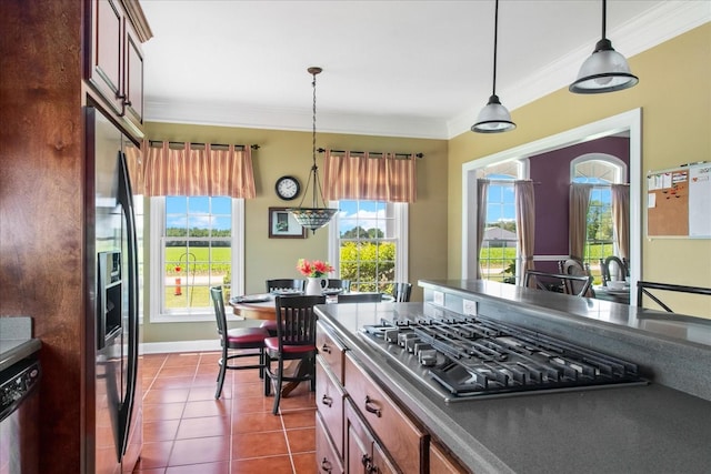95 Country Ln, Lawrenceburg, TN 38464 - kitchen with stainless steel appliances, crown molding, dark countertops, plenty of natural light, and dark tile patterned flooring