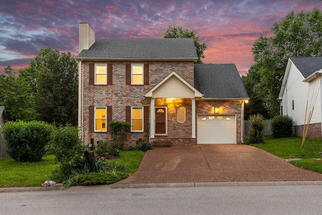 7728 Poplar Ridge Dr, Nashville, TN 37221 - traditional-style home featuring a garage, a chimney, concrete driveway, a yard, and brick siding