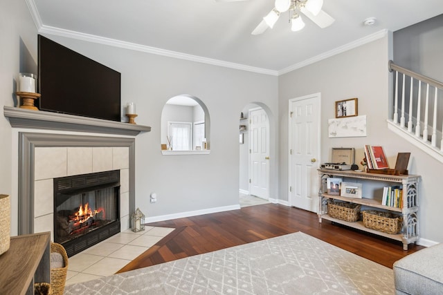 1101 Downs Blvd Unit 160, Franklin, TN 37064 - living area featuring a ceiling fan, wood finished floors, ornamental molding, arched walkways, and a tiled fireplace
