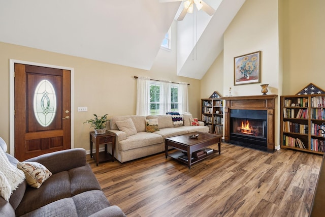2917 York Rd, Pleasant View, TN 37146 - living area with a fireplace with flush hearth, wood finished floors, high vaulted ceiling, a ceiling fan, and baseboards