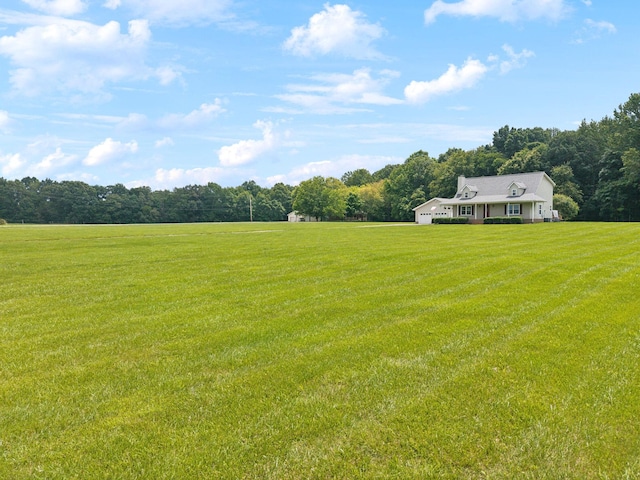 2917 York Rd, Pleasant View, TN 37146 - view of grassy yard featuring an attached garage, a wooded view, and a view of countryside