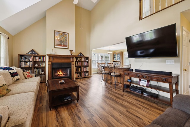 2917 York Rd, Pleasant View, TN 37146 - living room with wood finished floors, high vaulted ceiling, a glass covered fireplace, a ceiling fan, and a chandelier