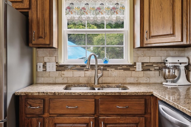 2917 York Rd, Pleasant View, TN 37146 - kitchen with appliances with stainless steel finishes, a sink, tasteful backsplash, brown cabinetry, and light stone countertops