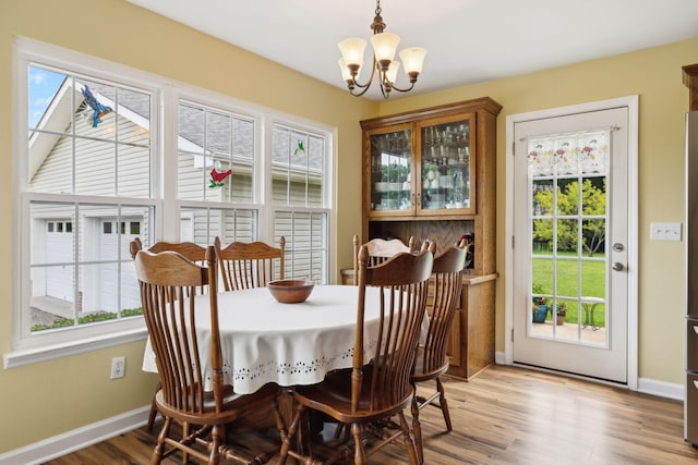 2917 York Rd, Pleasant View, TN 37146 - dining room with plenty of natural light, a chandelier, baseboards, and light wood-type flooring