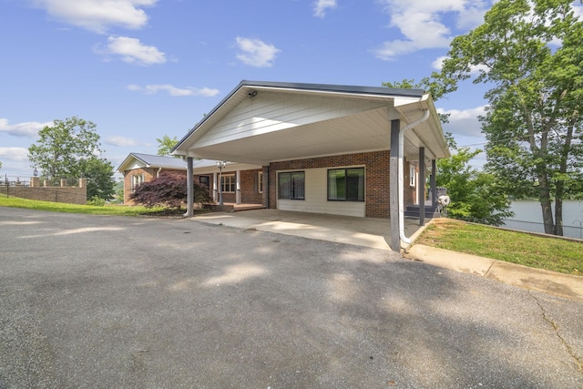 255 Whispering Hills Dr, Dover, TN 37058 - view of front of property featuring brick siding, asphalt driveway, and a carport