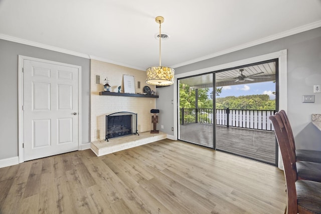 255 Whispering Hills Dr, Dover, TN 37058 - unfurnished living room with ornamental molding, wood finished floors, baseboards, a brick fireplace, and a water view