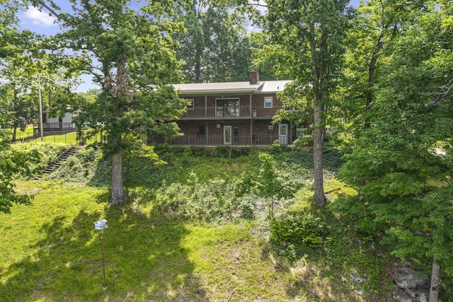 255 Whispering Hills Dr, Dover, TN 37058 - back of house with a chimney, a balcony, and metal roof