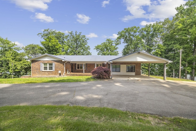 255 Whispering Hills Dr, Dover, TN 37058 - single story home with asphalt driveway, brick siding, a carport, and a front lawn