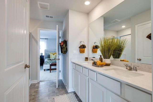 1752 Wren Way, Lebanon, TN 37087 - ensuite bathroom featuring double vanity, baseboards, a shower, and stone finish floors