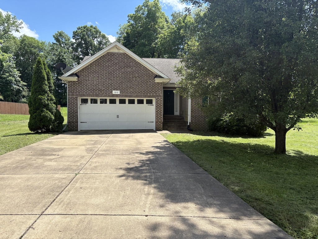 100 Hickory Pointe, Dickson, TN 37055 - view of front of house featuring brick siding, concrete driveway, and an attached garage
