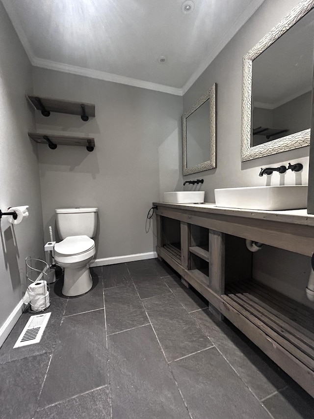 13276 Old Baxter Rd, Silver Point, TN 38582 - bathroom featuring ornamental molding, toilet, double vanity, and baseboards