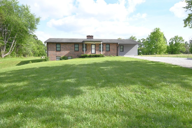13276 Old Baxter Rd, Silver Point, TN 38582 - view of front of home with brick siding, a front yard, and a chimney