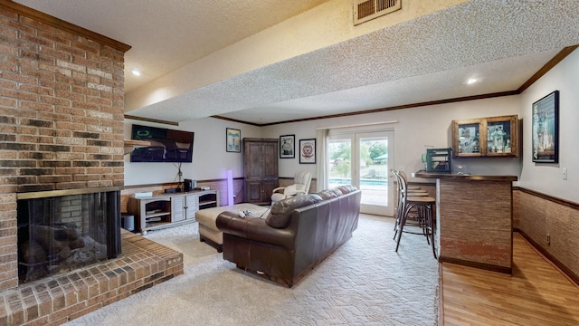 305 Rolling Mill Rd, Old Hickory, TN 37138 - living area with a textured ceiling, wainscoting, ornamental molding, a brick fireplace, and wood finished floors
