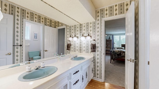 305 Rolling Mill Rd, Old Hickory, TN 37138 - ensuite bathroom featuring wallpapered walls, wood finished floors, double vanity, and toilet