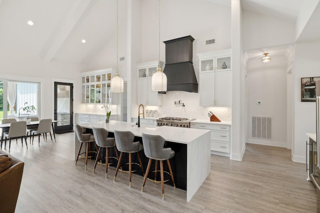 2648 Wilson Overall Rd, Murfreesboro, TN 37127 - kitchen featuring custom exhaust hood, high vaulted ceiling, light countertops, a sink, and decorative backsplash