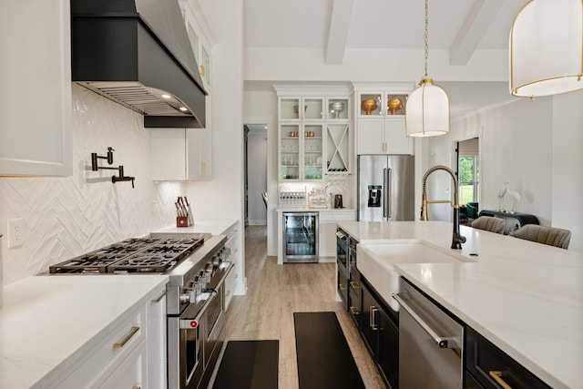 2648 Wilson Overall Rd, Murfreesboro, TN 37127 - kitchen with custom range hood, premium appliances, wine cooler, and white cabinets