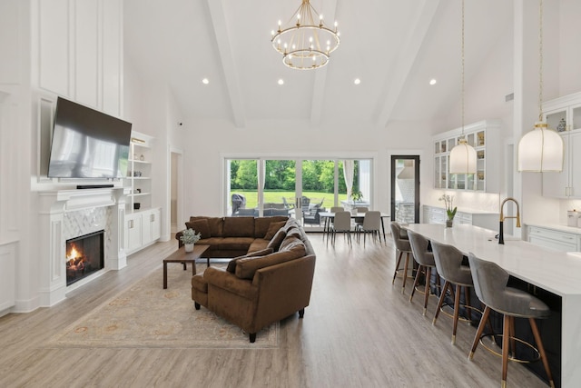 2648 Wilson Overall Rd, Murfreesboro, TN 37127 - living room with high vaulted ceiling, light wood-style flooring, beamed ceiling, a fireplace, and a chandelier